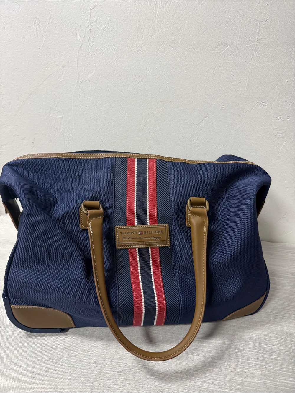 Tommy Hilfiger Navy rolling Duffel with Red & White Center Stripe  carry on